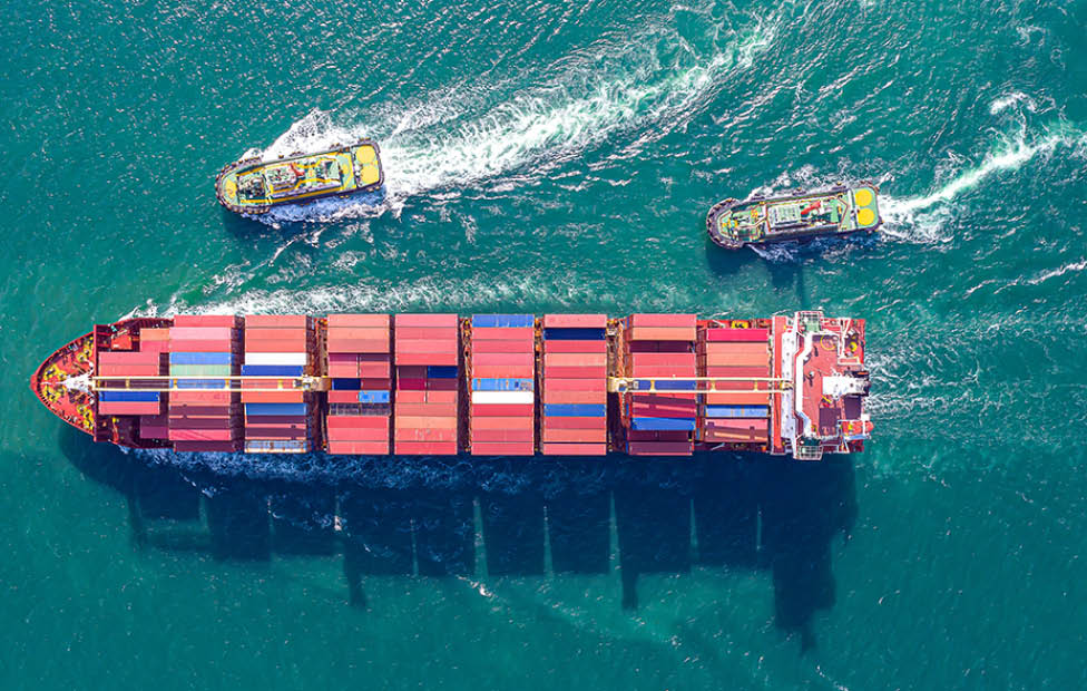 Aerial top view of cargo ship carrying container for import export goods  to customer,concept logistic and supply chain 
